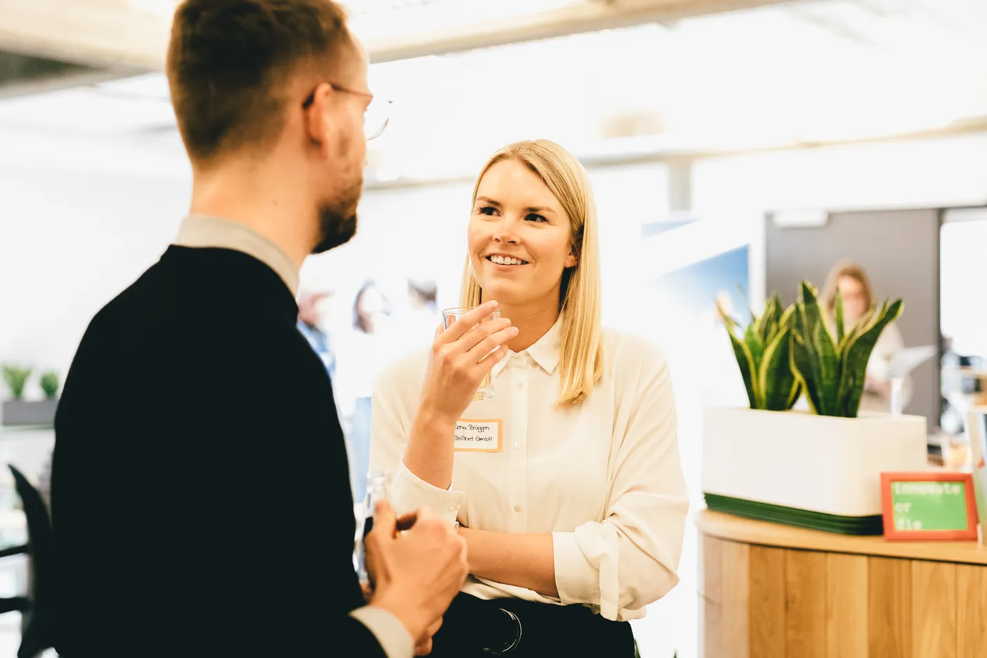 A founder and a corporate partner talking at an NCA event