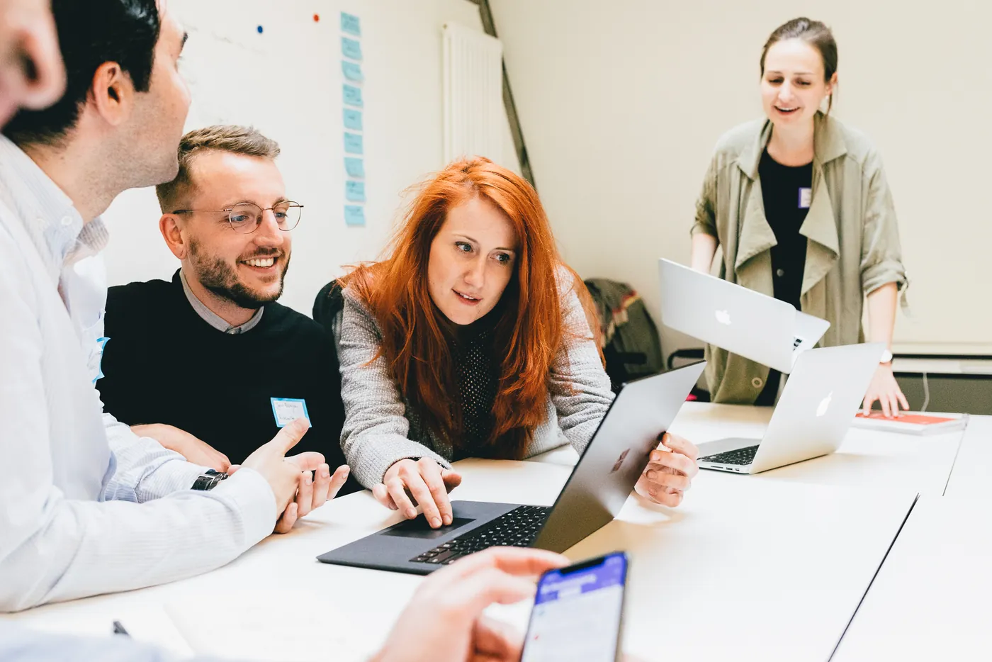 Founders gathered around a laptop during an NCA workshop